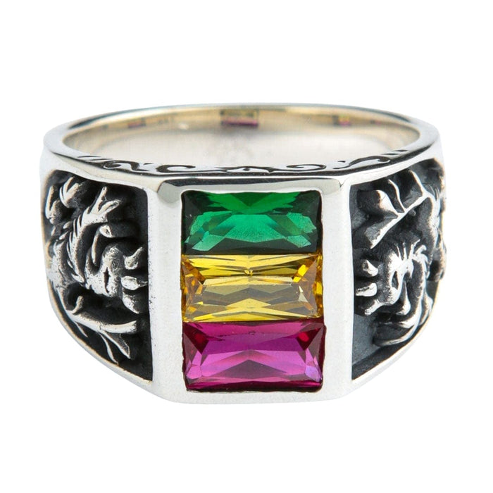 A sterling silver Lion of Judah ring with green, yellow, and red Rasta colored gemstones on a white background.