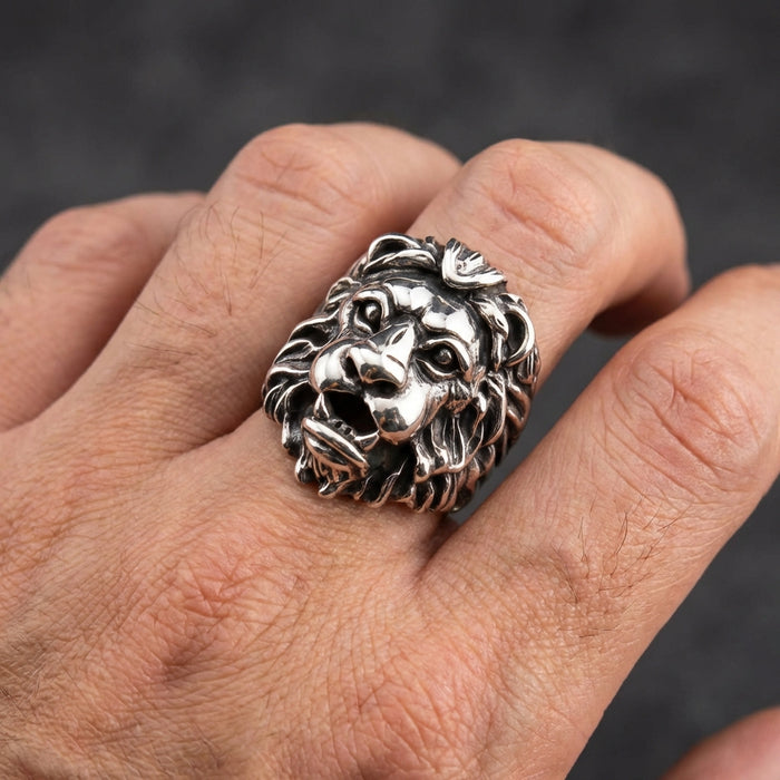 A model's hand wearing the heavy sterling silver lion ring to demonstrate its substantial size and impressive scale.
