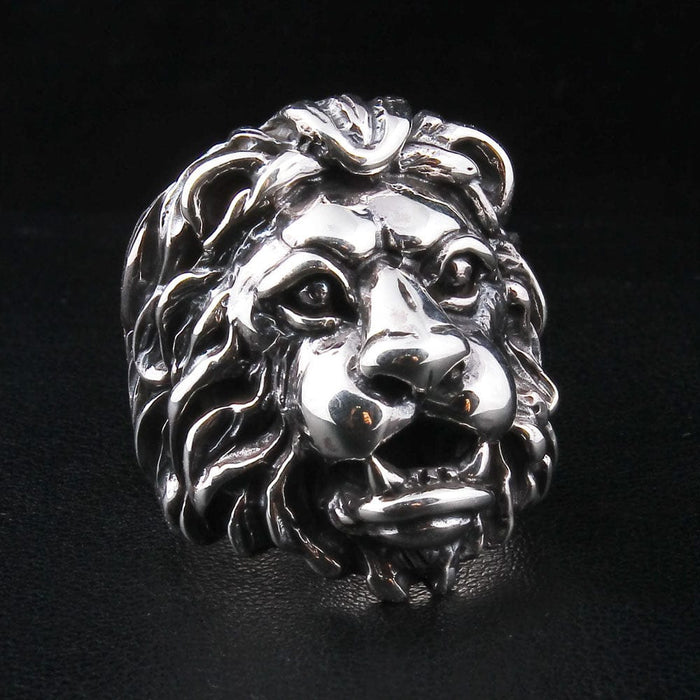 A sterling silver lion ring with a realistic and majestic facial expression, shown on a black background.