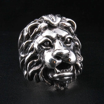 A sterling silver lion ring with a realistic and majestic facial expression, shown on a black background.