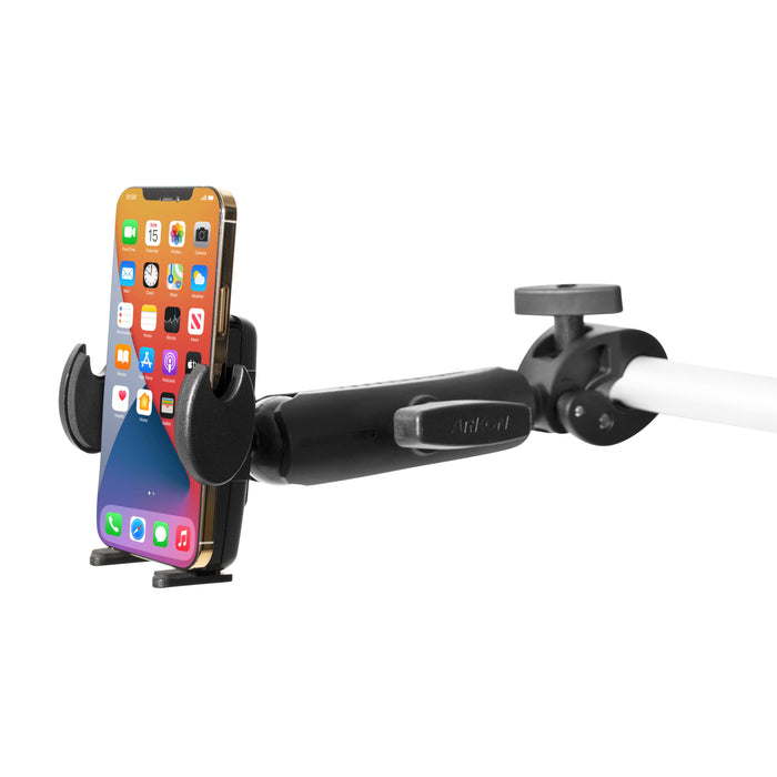 A smartphone is secured in the Mega Grip RoadVise® Clamp Mount with a 5.75” arm, attached to a white pole. The phone, showing multiple app icons, rests horizontally in the sturdy black universal holder.