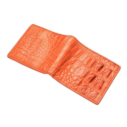 An angled view of the open orange crocodile wallet, contrasting the textured backbone exterior with the smooth leather interior.