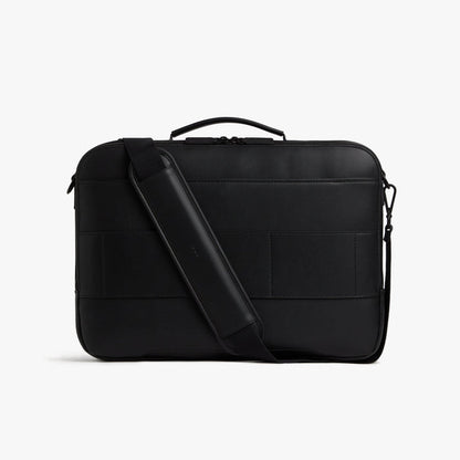 Carbon Black (Vegan Leather) | Back view of Metro Briefcase in Carbon Black with shoulder strap in front