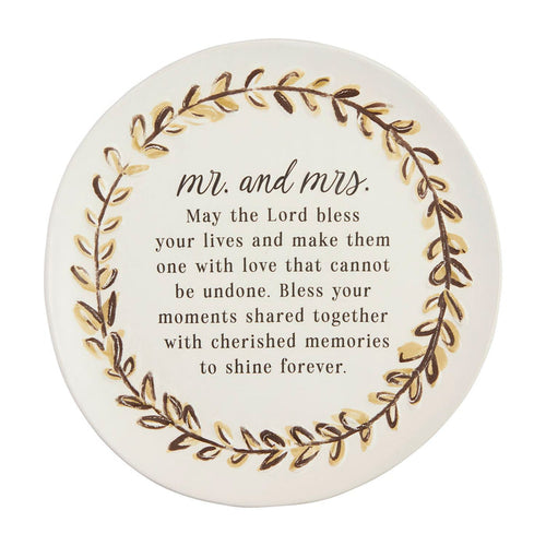 Round decorative item with 'Mr. and Mrs.' text and floral design on a white background