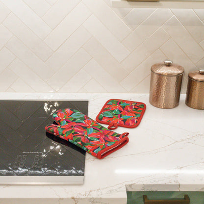 Oven mitt and pot holder in poinsettia pattern on a kitchen counter
