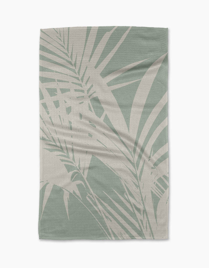 Towel with palm leaf pattern on a white background