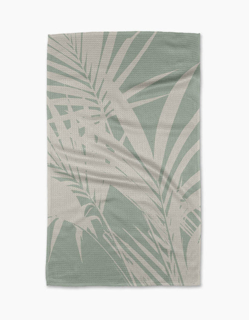 Towel with palm leaf pattern on a white background