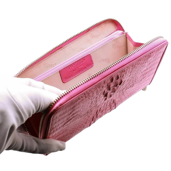 The interior of the pink crocodile wallet, showing the branded lining and zip compartment.
