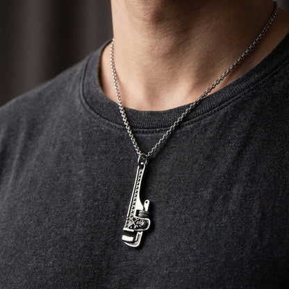 Sterling silver wrench skull pendant worn on neck chain