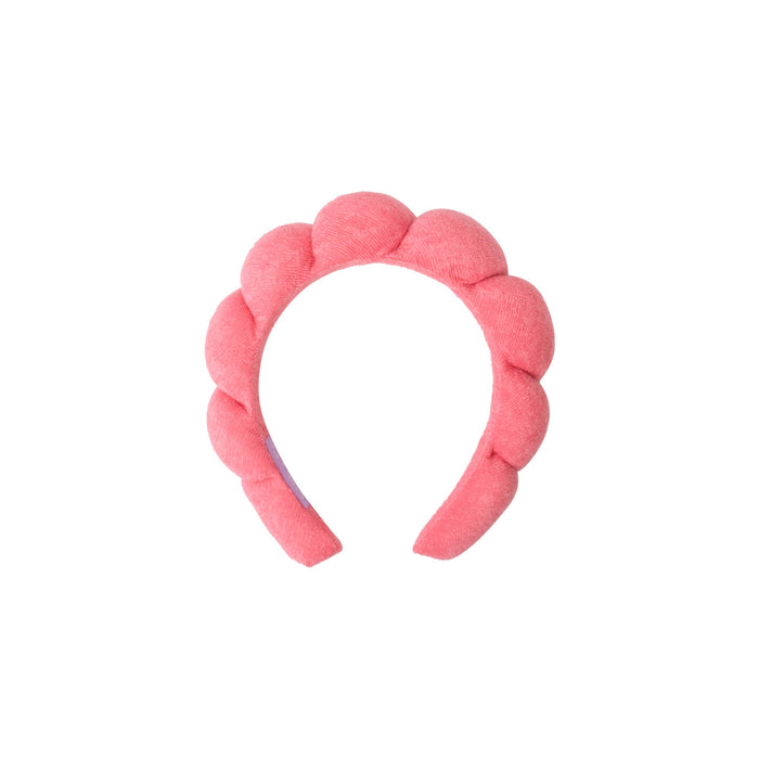 pink spa plush headband against a white background