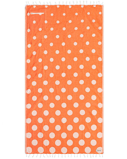 Orange towel with white polka dots on a white background