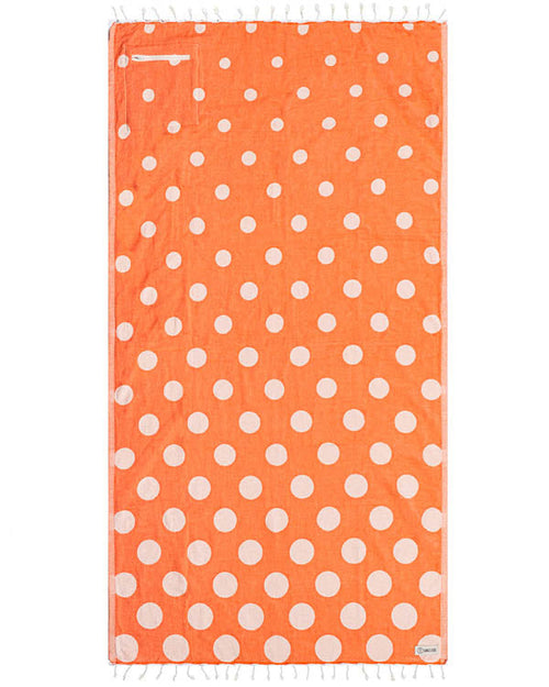 Orange towel with white polka dots on a white background