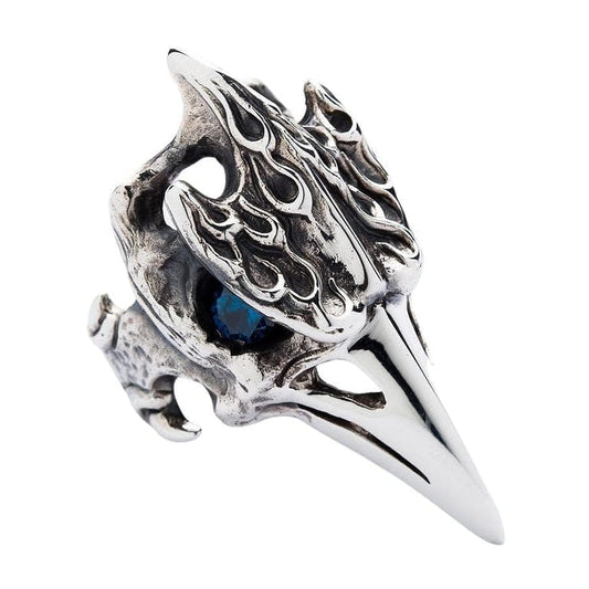 A large, gothic raven skull ring made of solid sterling silver with a blue topaz eye.