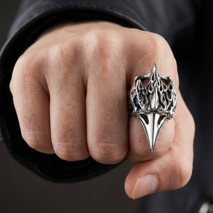 A man's fist wearing the oversized, 30-gram raven skull ring to show its large scale.