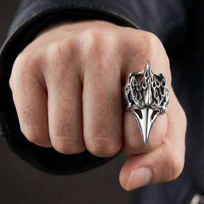 A man's fist wearing the oversized, 30-gram raven skull ring to show its large scale.