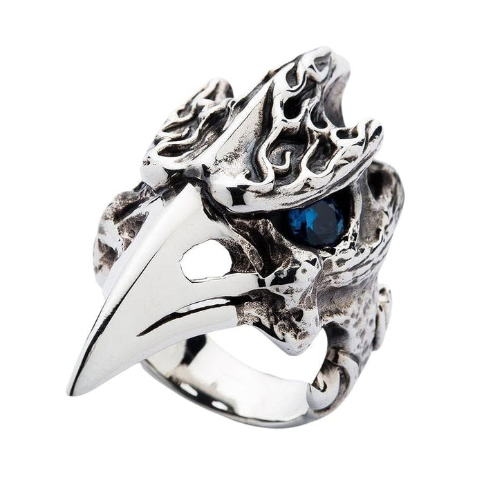 An angled view of the raven skull ring, highlighting the carved flame details on its cranium.