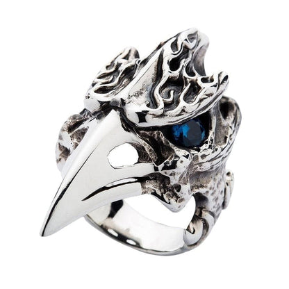 An angled view of the raven skull ring, highlighting the carved flame details on its cranium.