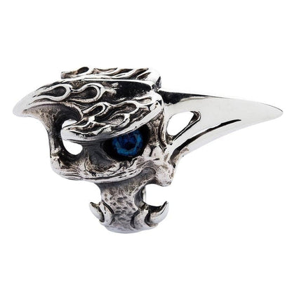 A profile view of the heavy silver raven ring, showing the long, polished beak and textured bone.