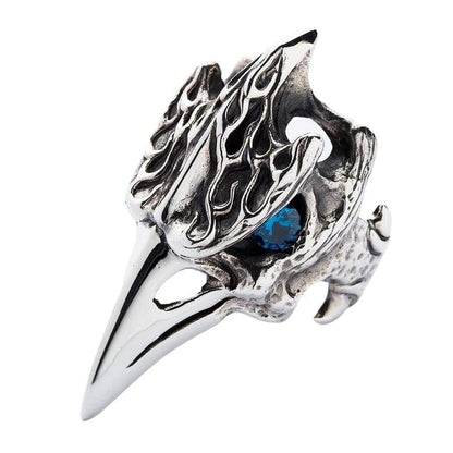 A three-quarters view of the Viking-style raven skull ring with a blue eye.