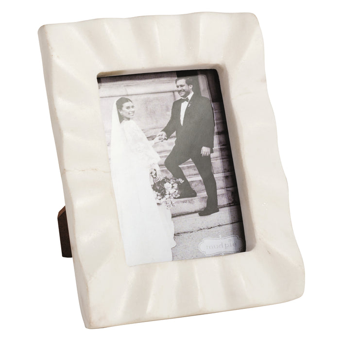 White photo frame with a black and white photograph inside on a white background
