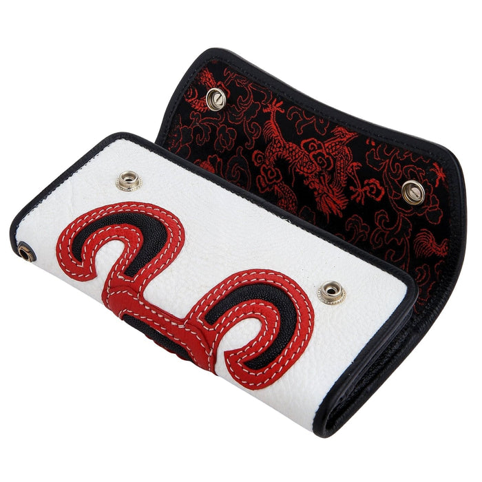 Partially open white stingray leather trifold biker wallet with a red and black stitched devil skull on the front, revealing a black interior with red dragon patterns