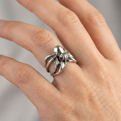 Handcrafted sterling silver octopus ring worn on finger demonstrating adjustable fit