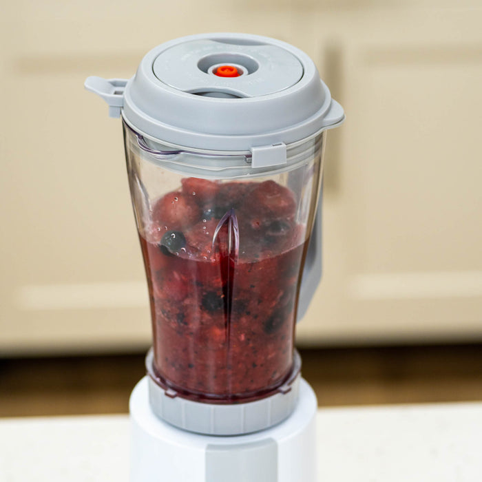 Up close of a NutriMill vacuum blender attachment blending berries