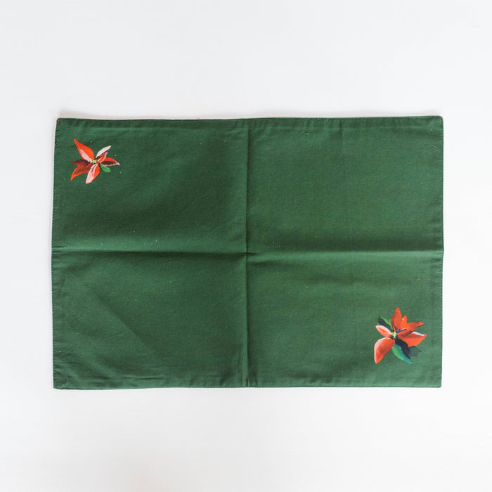 Green placement with floral decal against white background
