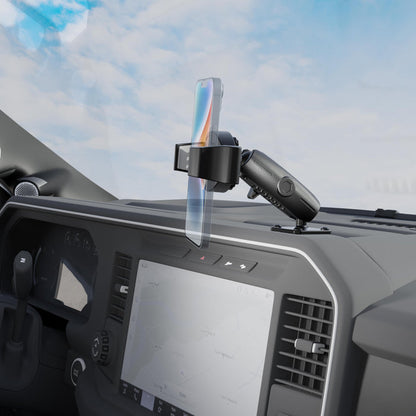 The RoadVise® Ultra Pro Phone Holder 5” AMPS Drill-Base Mount is securely attached to a car dashboard above the touchscreen display and air vents, with a smartphone mounted in place and a bright sky visible through the windshield.