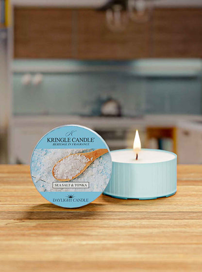 Kingle Candle with a lit candle on a wooden surface in a kitchen setting