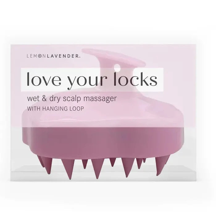 Pink scalp massager with packaging labeled 'love your locks' on a white background