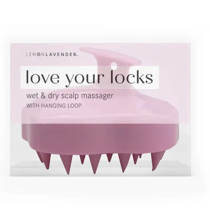 Pink scalp massager with packaging labeled 'love your locks' on a white background