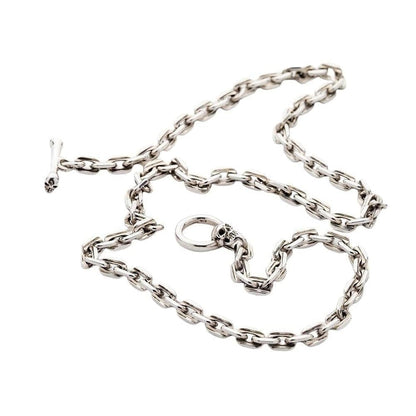 A full layout of the heavy 7mm sterling silver curb chain necklace with its unique skull and bone toggle clasp.