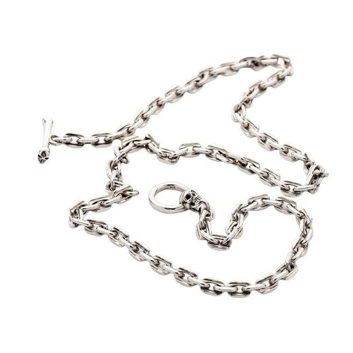 A full layout of the heavy 7mm sterling silver curb chain necklace with its unique skull and bone toggle clasp.