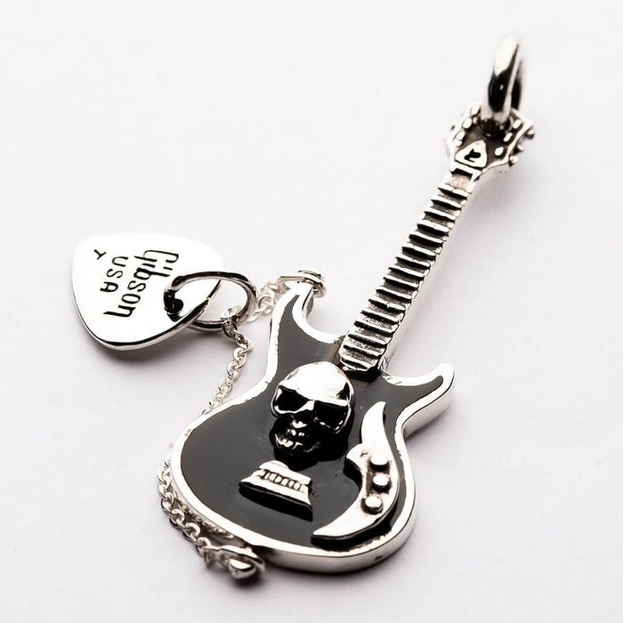 A handcrafted black skull guitar pendant in solid 925 silver with a dangling pick charm.