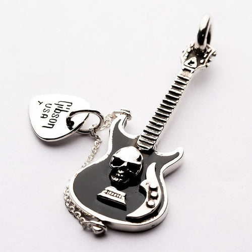 A handcrafted black skull guitar pendant in solid 925 silver with a dangling pick charm.