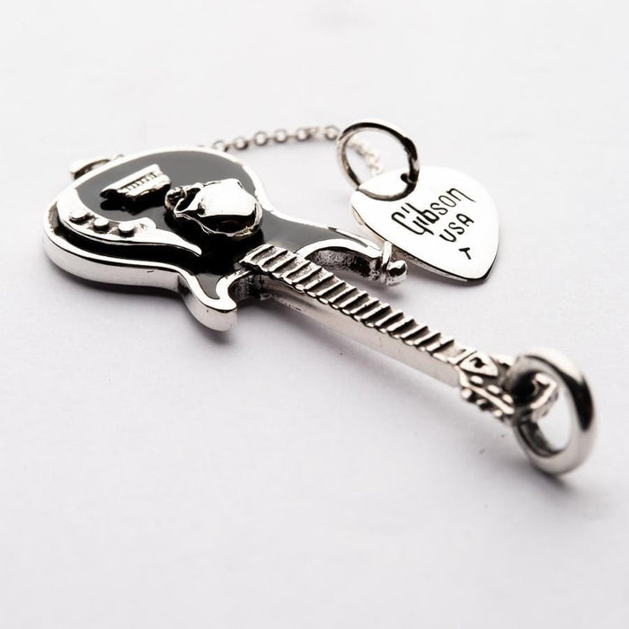 The silver guitar pick pendant with "Gibson USA" text.