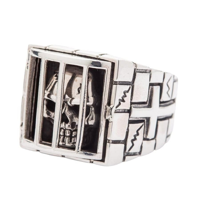 A premium piece of authentic biker jewelry: a heavy sterling silver ring of a skull trapped in a cage.