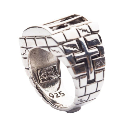 The inside of the heavy and solid caged skull ring, showing the .925 sterling silver hallmark stamp and intricate branding.