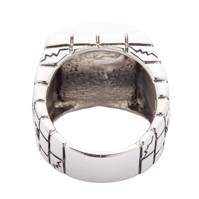 Rear of the cage showing engraved lines and zigzags on the band and the open space behind the skull setting.