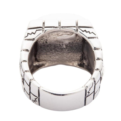 Rear of the cage showing engraved lines and zigzags on the band and the open space behind the skull setting.