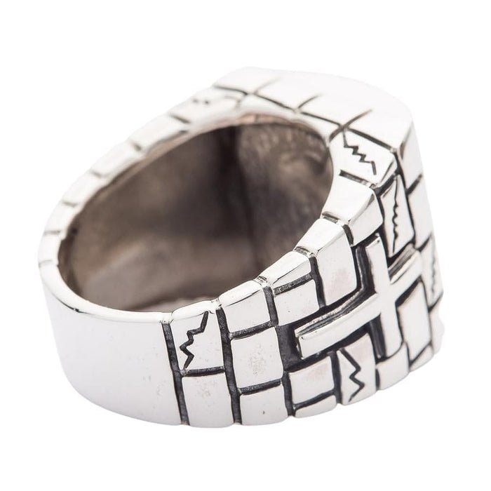A detailed side view of the prison ring, highlighting the cross emblem on the rugged stone wall band.