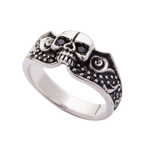 A gothic skull wedding ring in solid sterling silver, featuring a central skull and a band adorned with black pavé stones.