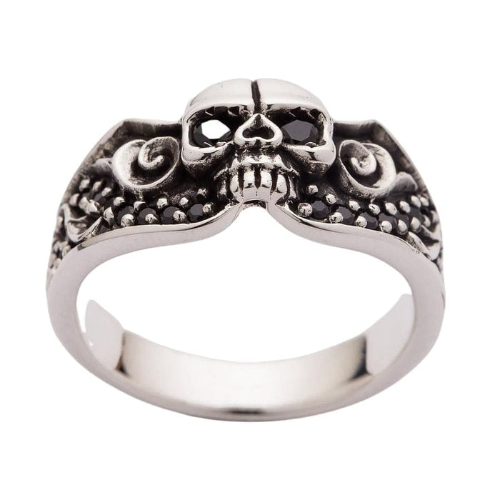 A unique alternative wedding band with a skull centerpiece, black stone eyes, and a detailed, flowing band design.