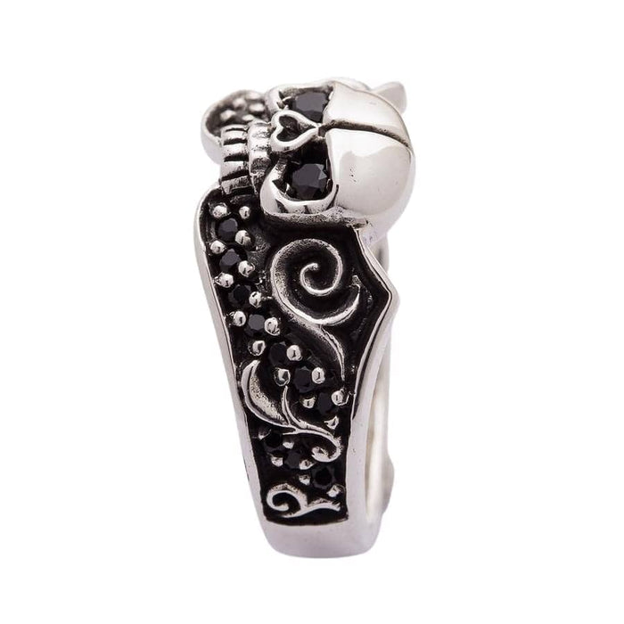 A beautiful sterling silver skull commitment ring with intricate gothic details and sparkling black gemstones.