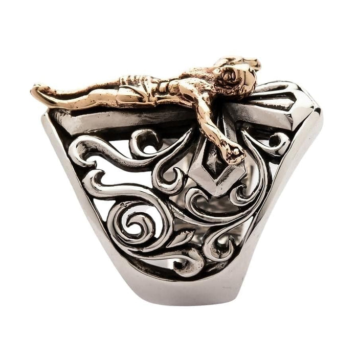 Top down view of sterling silver crucifix ring displaying bronze Christ figure and baroque silver scroll openwork