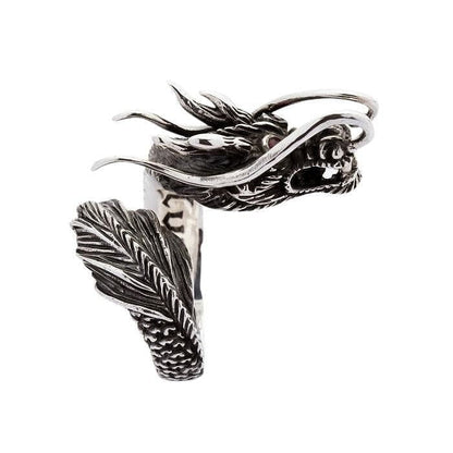 Handcrafted 925 sterling silver dragon ring with red CZ eyes showing detailed scales and feathered tail side view