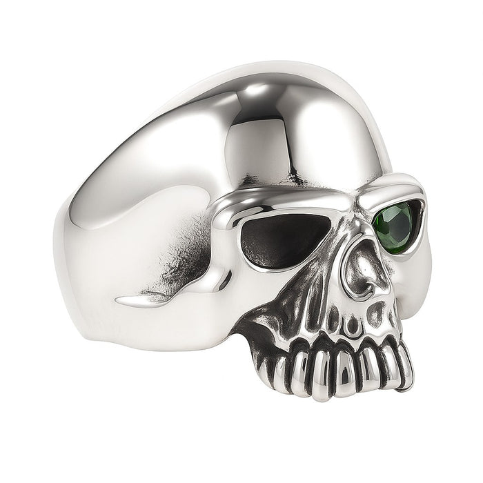 An angled, three-quarters view of the emerald skull ring in solid 925 sterling silver.