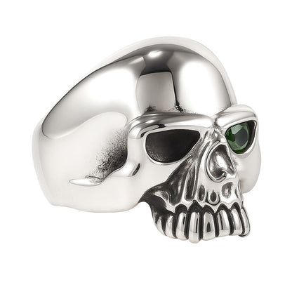 An angled, three-quarters view of the emerald skull ring in solid 925 sterling silver.