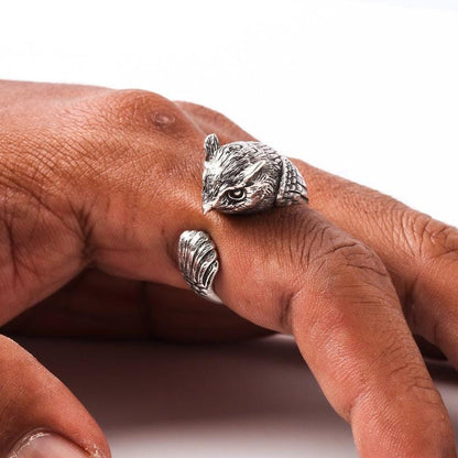 An angled view of the handmade silver bird ring, highlighting its three-dimensional craftsmanship.